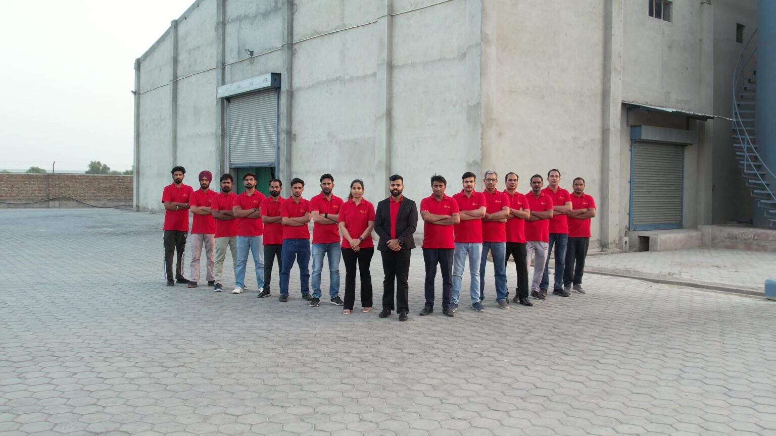 The Kasturi India team in red shirts outside their Kachi Ghani mustard oil factory in Sri Ganganagar, Rajasthan